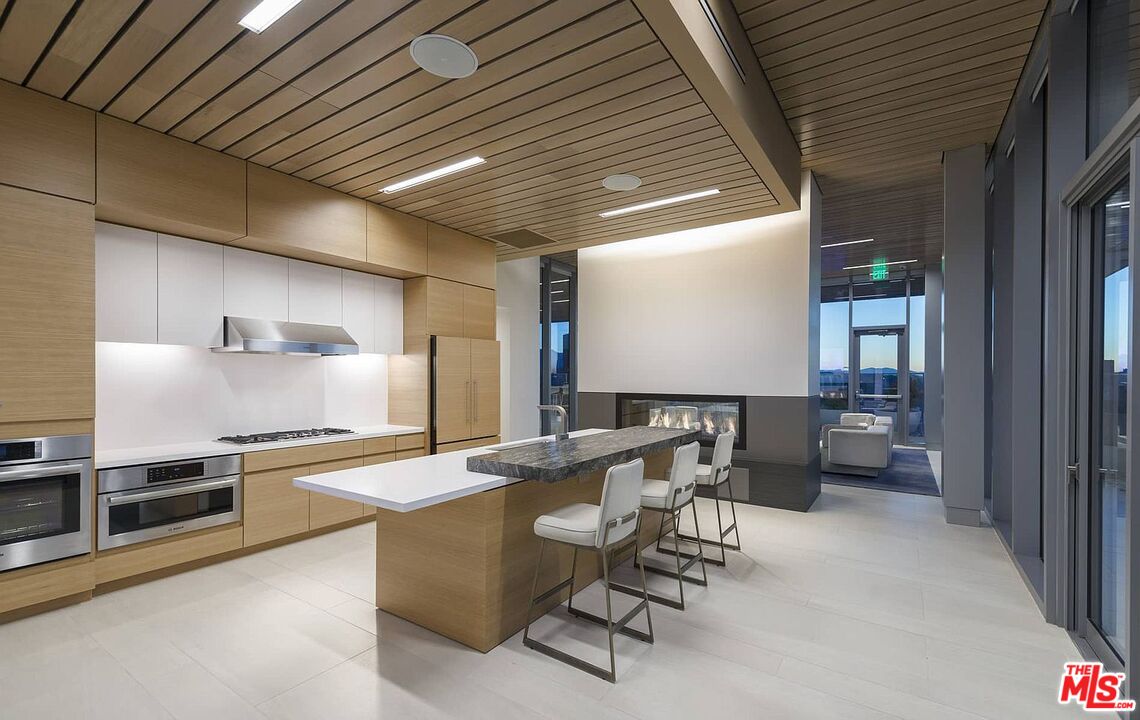 3033 Wilshire Boulevard, Unit 1113 Los Angeles, CA 90020 - Photo 2 of 31 a room with stainless steel appliances kitchen island granite countertop lots of counter space and a sink