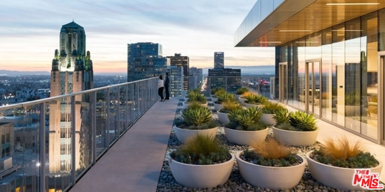 3033 Wilshire Boulevard, Unit 1113 Los Angeles, CA 90020 - Photo 28 of 31 a view of a balcony with chair and potted plants