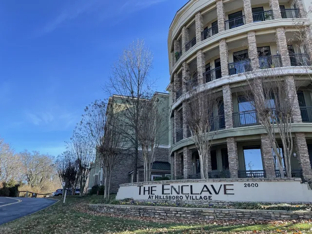 a front view of a residential apartment building with a yard