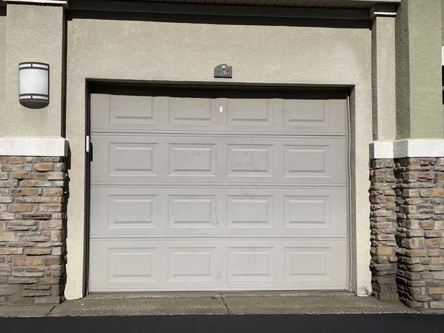 a living room with couches and kitchen view with wooden floor