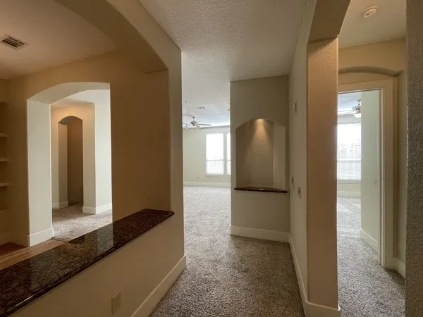 a view of a hallway with two rooms