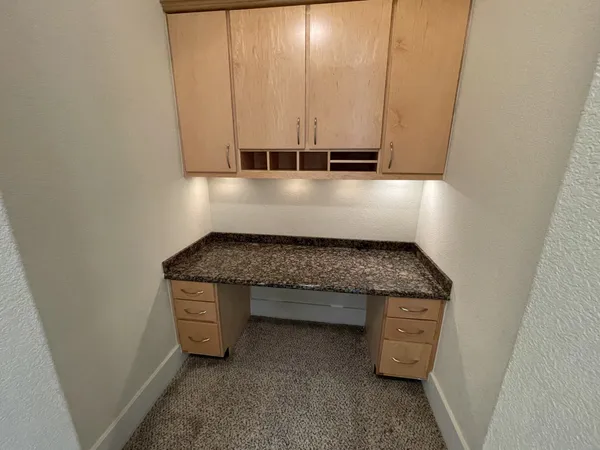 a kitchen with granite countertop a sink and a stove