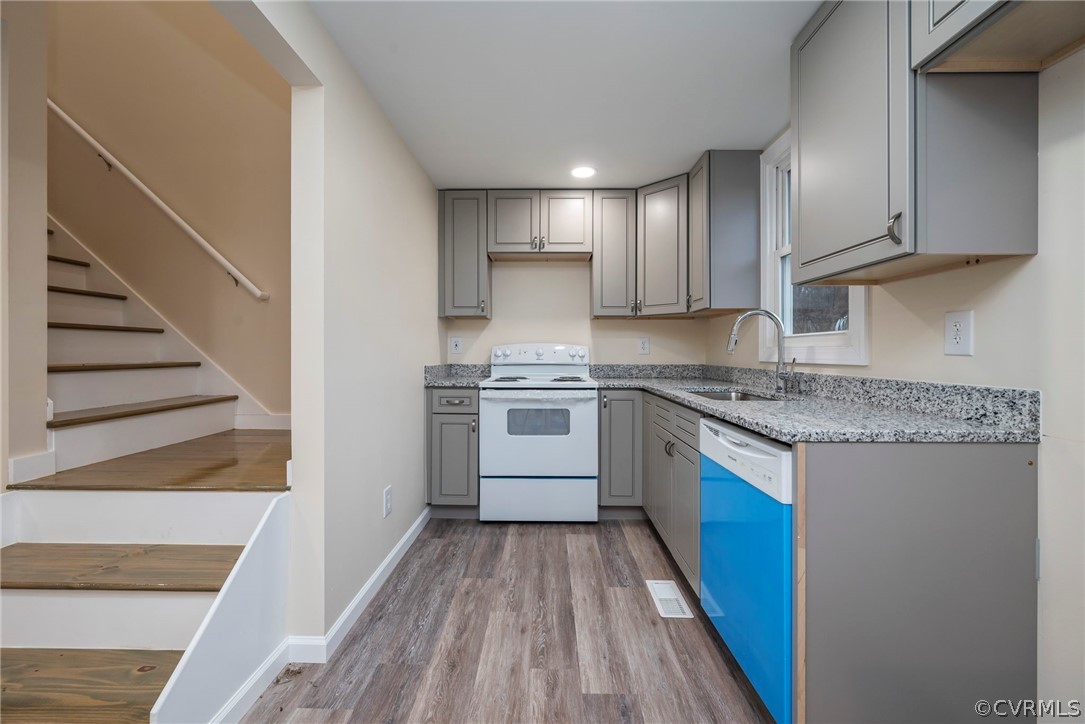 916 Nutbush Road Victoria, VA 23974 - Photo 11 of 25 a kitchen with granite countertop white cabinets and white appliances