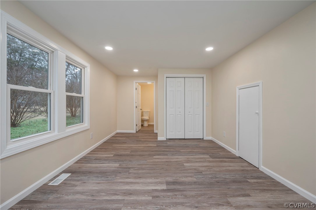 916 Nutbush Road Victoria, VA 23974 - Photo 13 of 25 a view of an empty room with wooden floor and a window