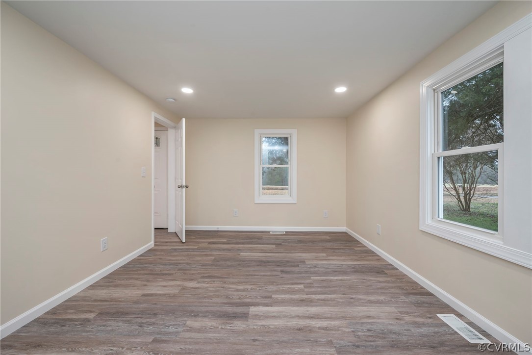 916 Nutbush Road Victoria, VA 23974 - Photo 14 of 25 a view of an empty room with wooden floor and a window