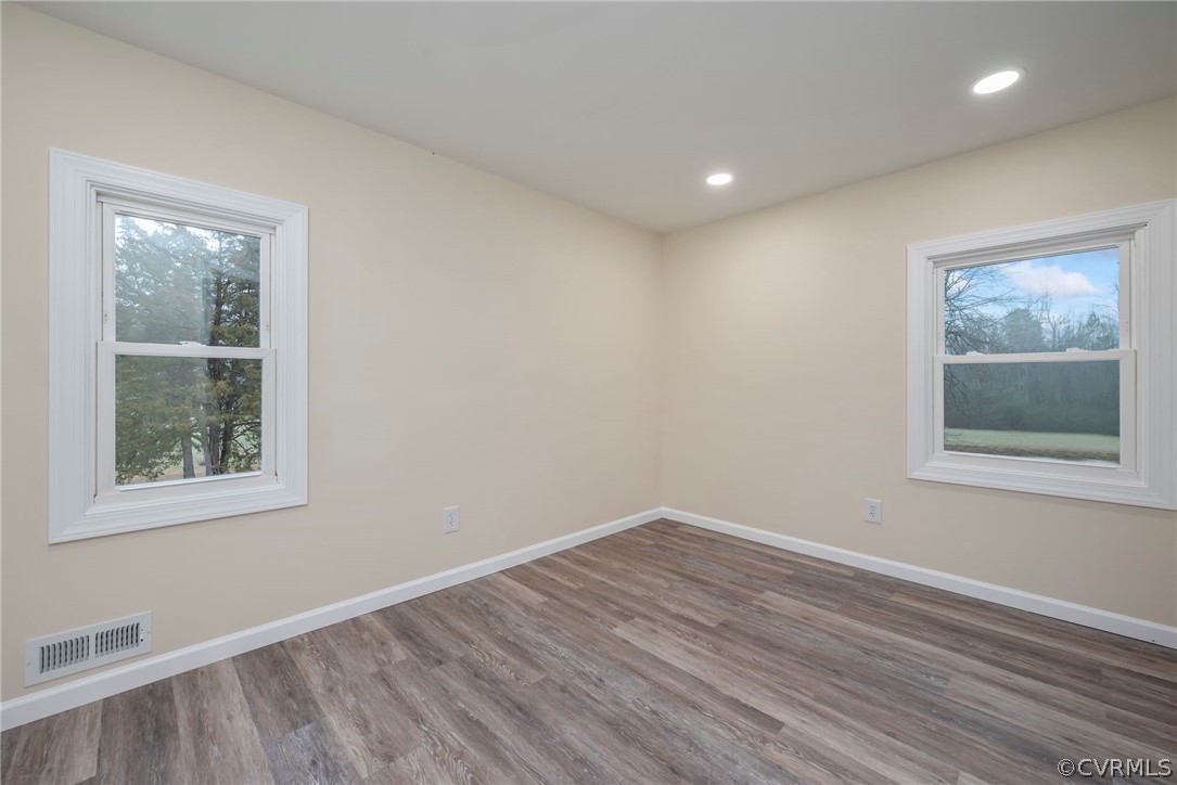 916 Nutbush Road Victoria, VA 23974 - Photo 20 of 25 a view of an empty room with wooden floor and a window