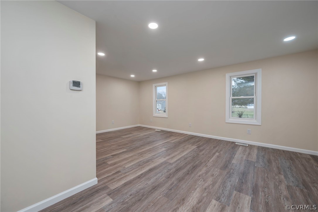 916 Nutbush Road Victoria, VA 23974 - Photo 9 of 25 a view of an empty room with wooden floor and a window