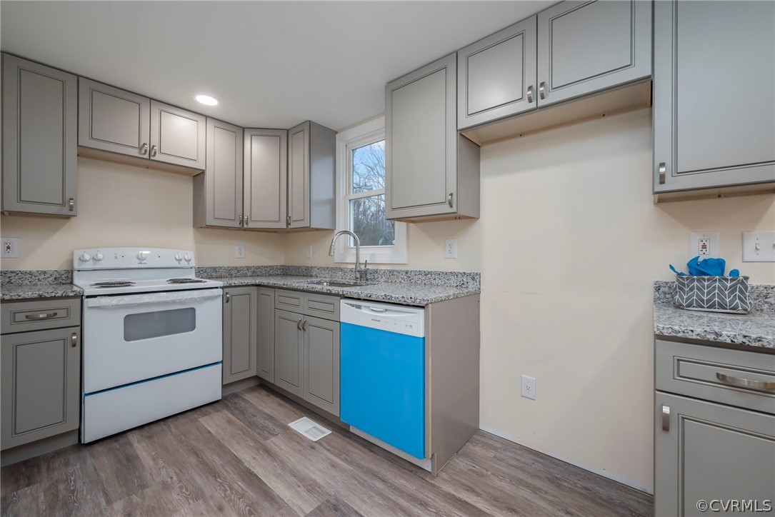 916 Nutbush Road Victoria, VA 23974 - Photo 10 of 25 a kitchen with granite countertop cabinets stainless steel appliances and wooden floor