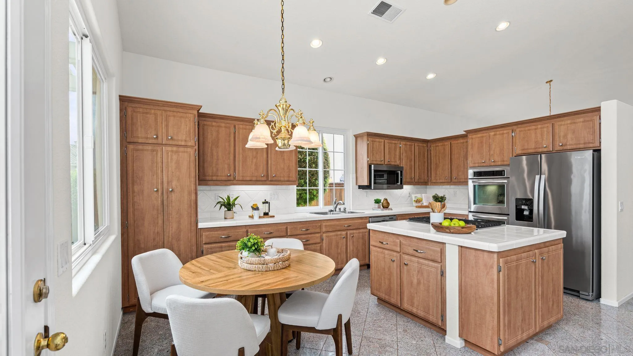 1783 Medinah Road San Marcos, CA 92069 - Photo 7 of 39 a kitchen that has a lot of cabinets in it and stainless steel appliances