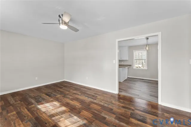 a view of empty room with wooden floor