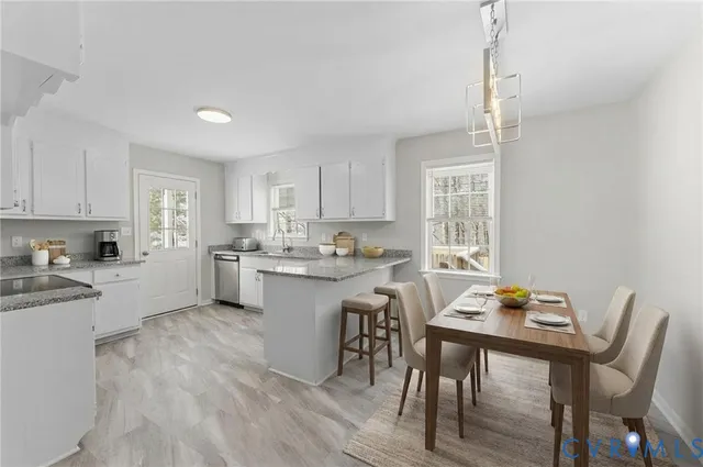 a kitchen with a table chairs stove and cabinets