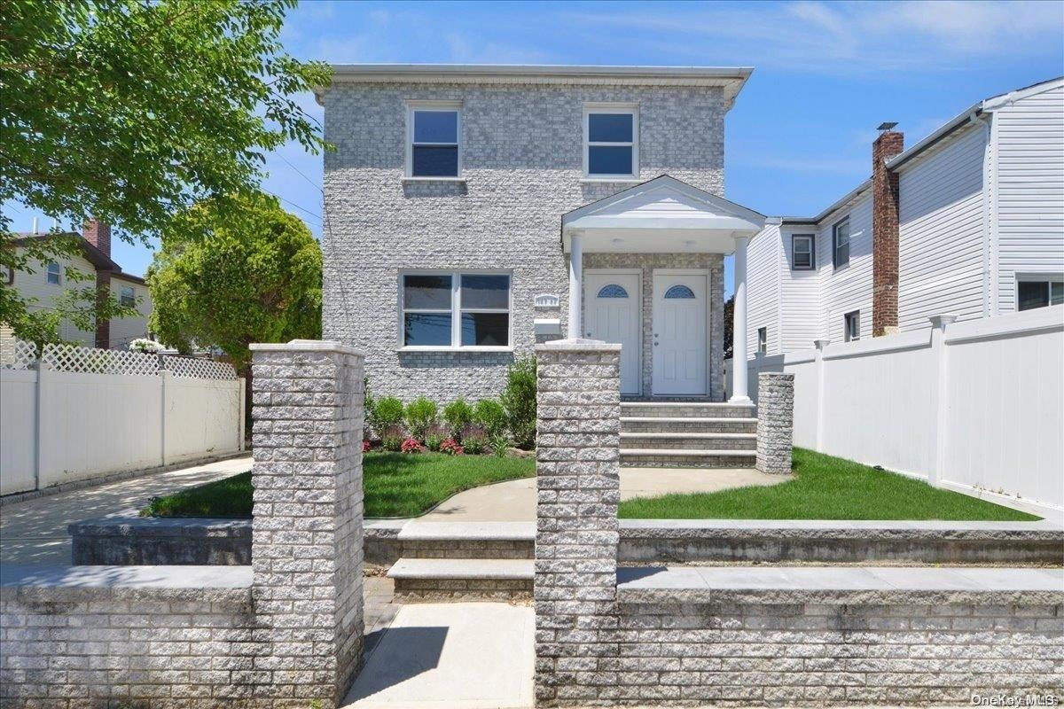 147-52 230th Street Queens, NY 11413 - Photo 1 of 1 a front view of a house with a yard and garage