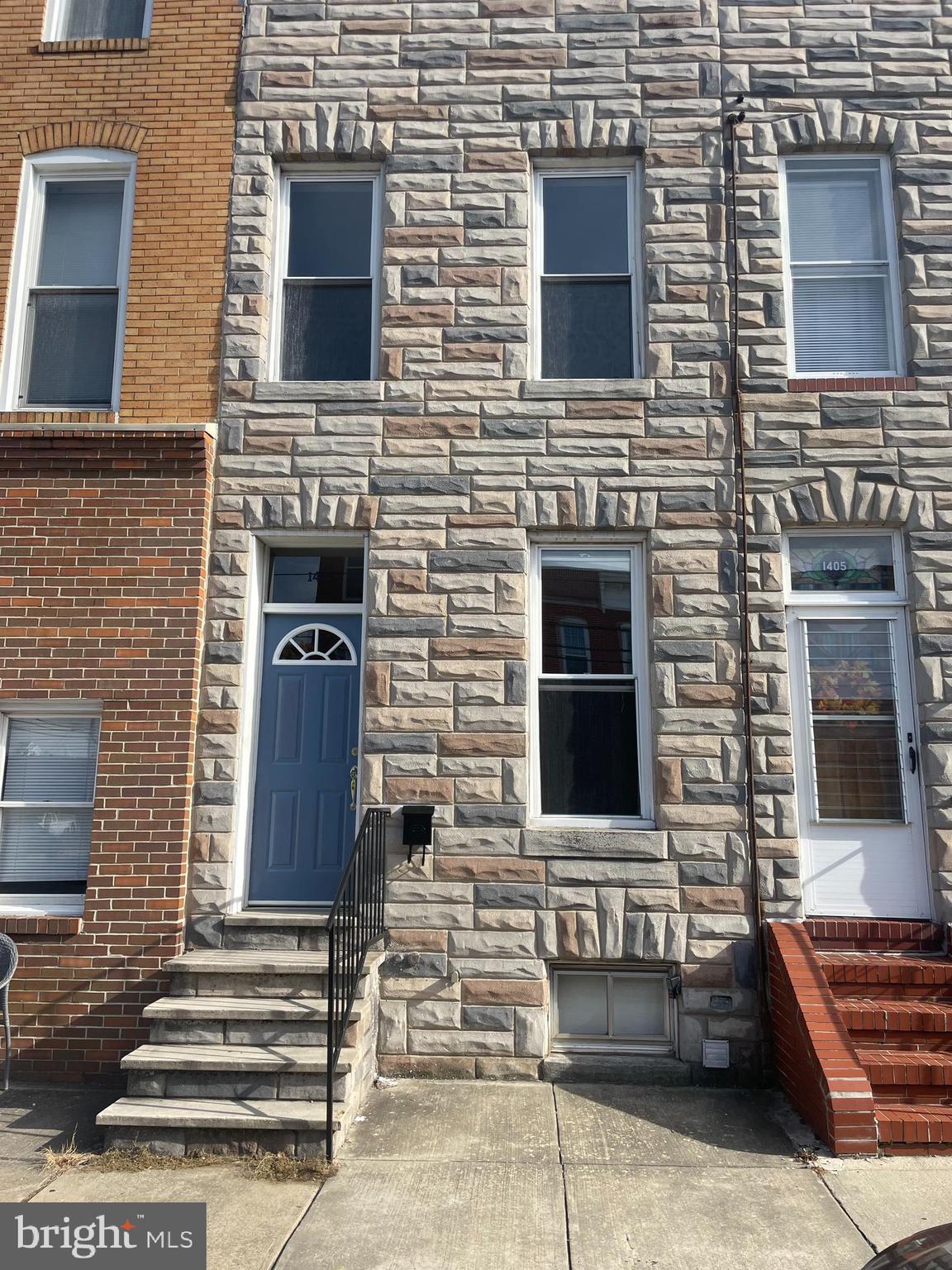 a front view of a house with stairs