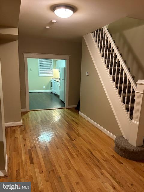1403 Hull Street Baltimore, MD 21230 - Photo 12 of 15 a view of an empty room with wooden floor and stairs