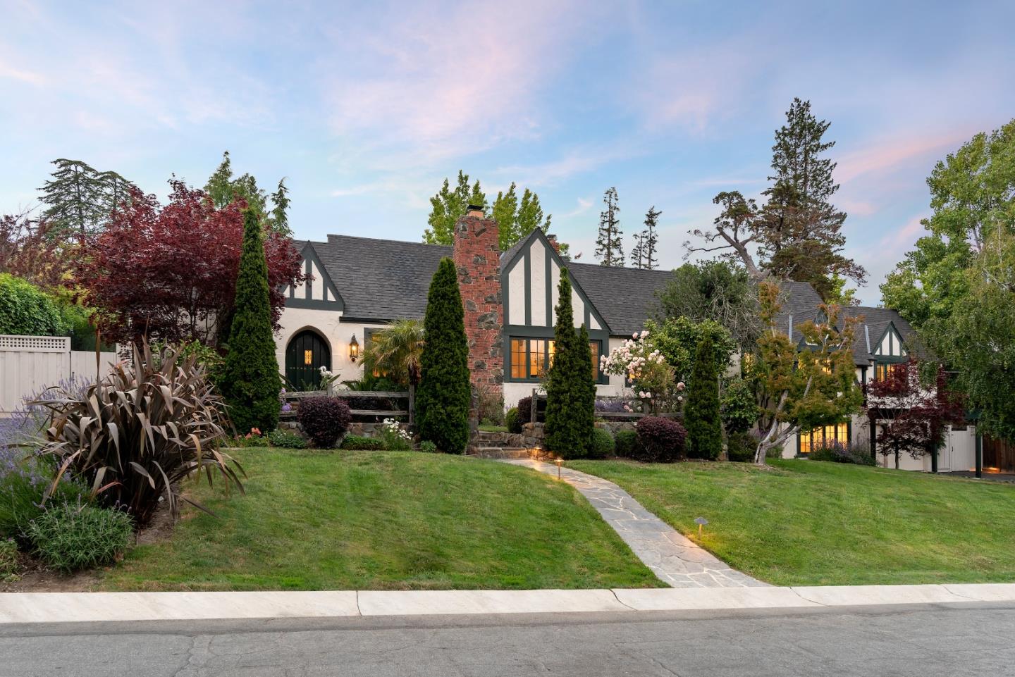 a front view of house with a garden