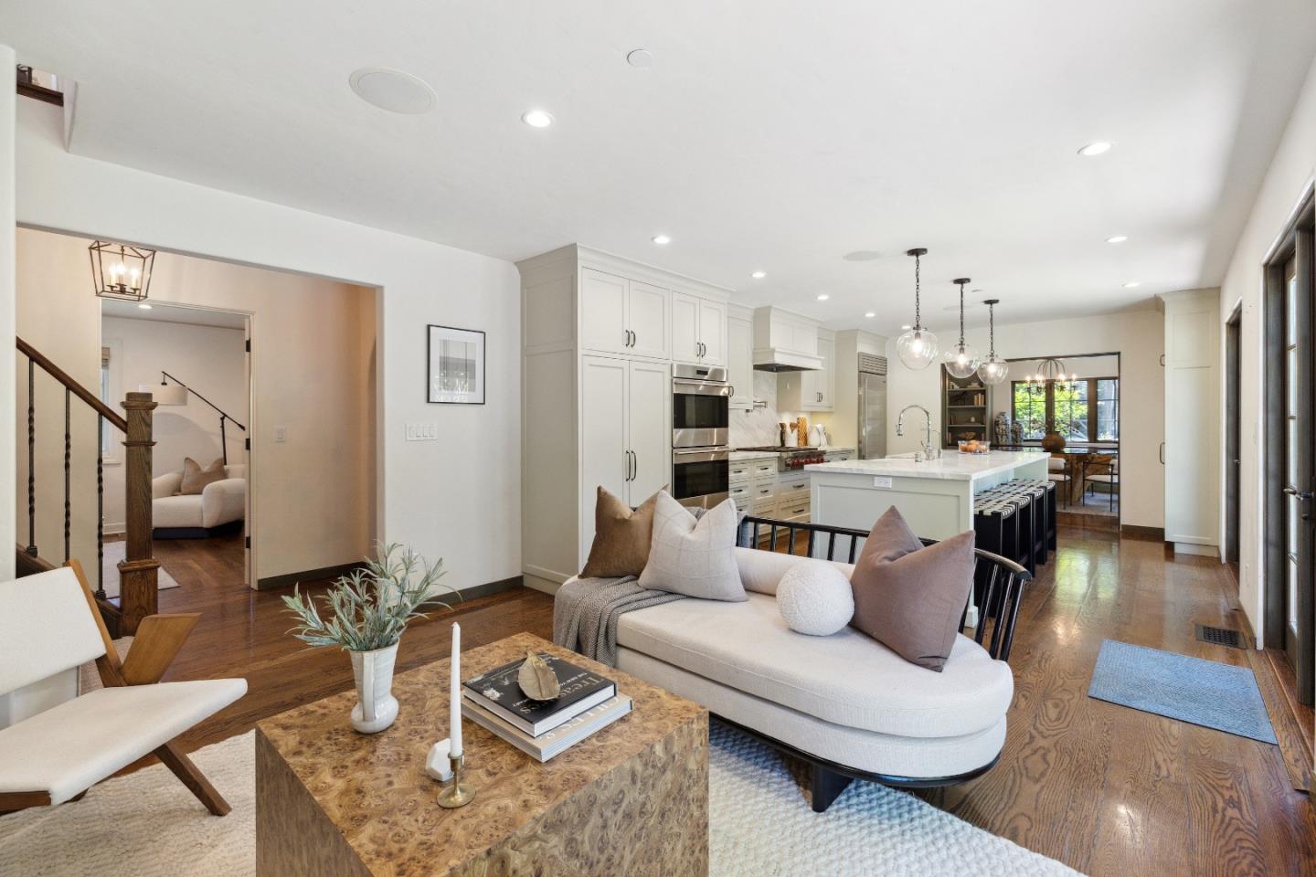540 Chelmsford Road Hillsborough, CA 94010 - Photo 17 of 49 a living room with furniture kitchen view and a wooden floor