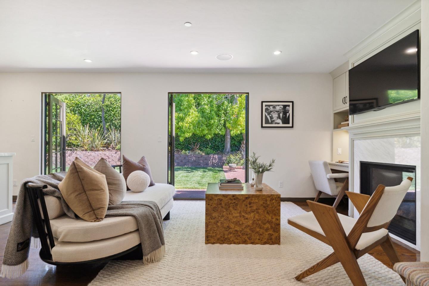 540 Chelmsford Road Hillsborough, CA 94010 - Photo 18 of 49 a living room with furniture a flat screen tv and a fireplace