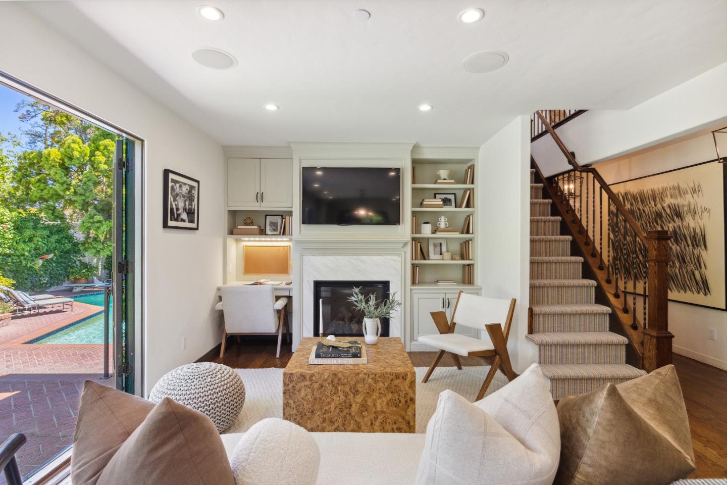 540 Chelmsford Road Hillsborough, CA 94010 - Photo 19 of 49 a living room with furniture a flat screen tv and a fireplace