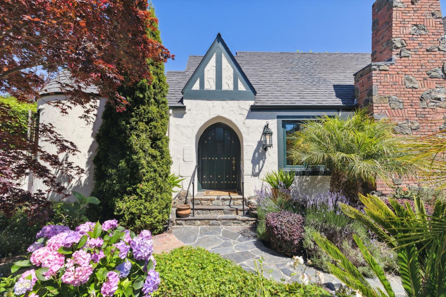 540 Chelmsford Road Hillsborough, CA 94010 - Photo 3 of 49 a front view of a house with a yard and fountain