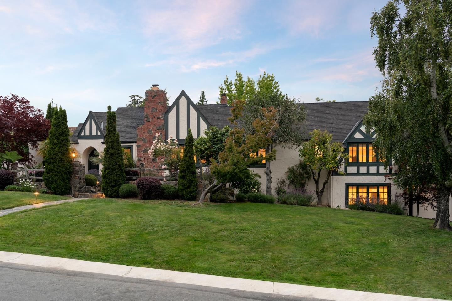 540 Chelmsford Road Hillsborough, CA 94010 - Photo 40 of 49 a view of a white house next to a yard with big trees