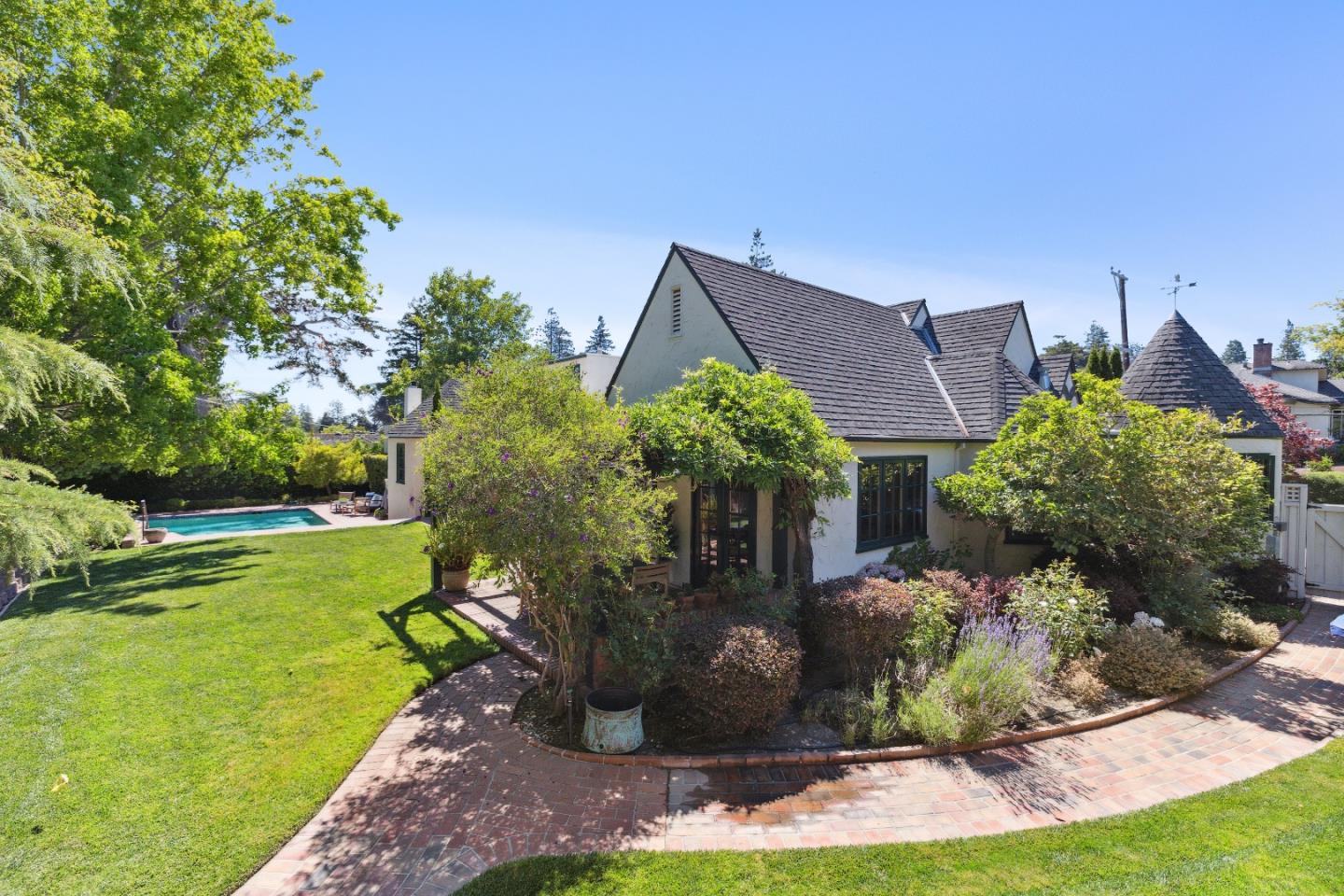 540 Chelmsford Road Hillsborough, CA 94010 - Photo 42 of 49 a view of a house with a yard and potted plants