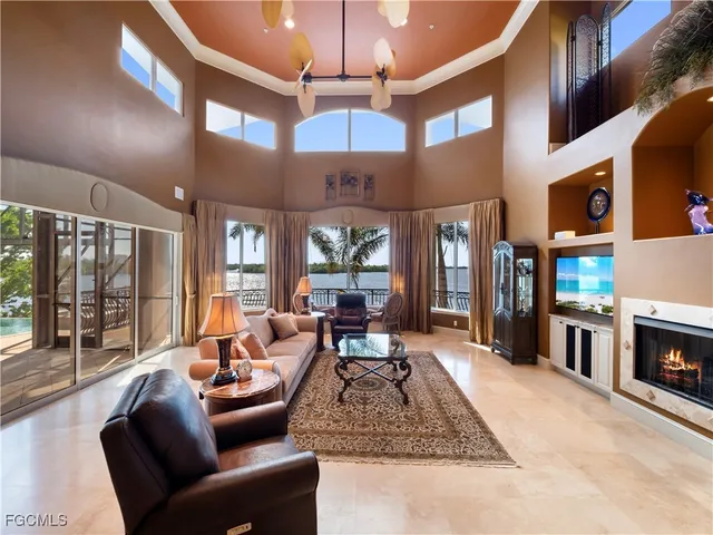 a living room with fireplace furniture and a large window