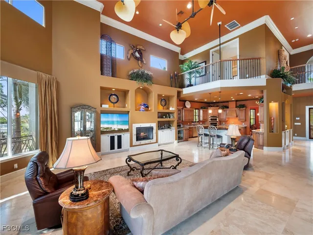 a living room with fireplace furniture and a large window