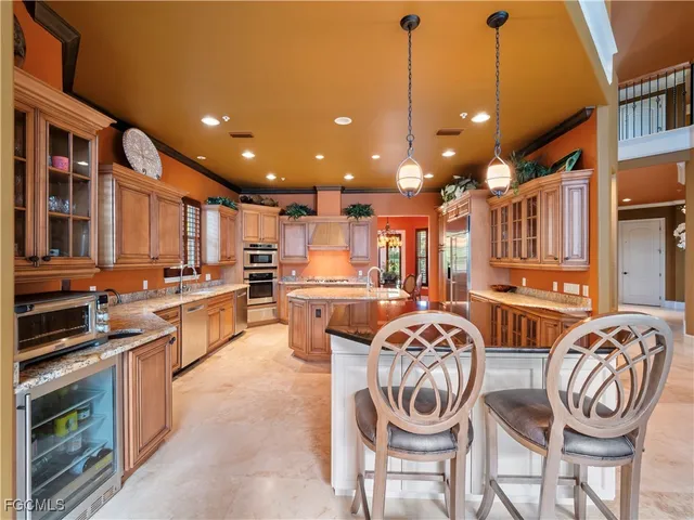 a kitchen with stainless steel appliances granite countertop a sink and a refrigerator