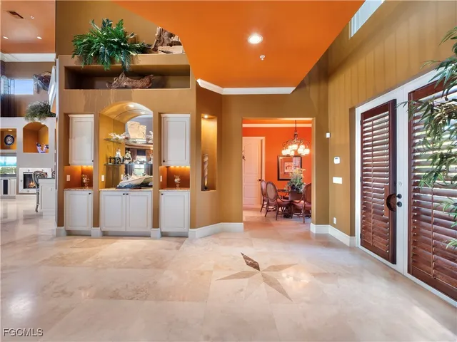 a dining room with furniture a chandelier and wooden floor