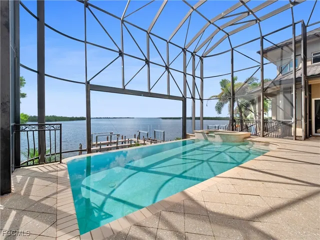 an aerial view of a golf course with a lake view