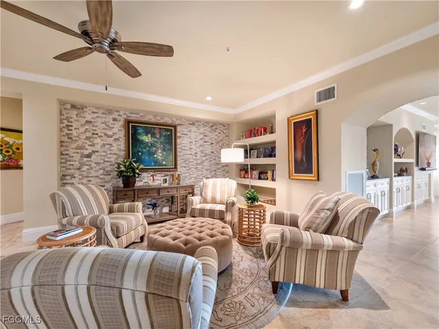 a large living room with stainless steel appliances kitchen island granite countertop couches and a coffee table