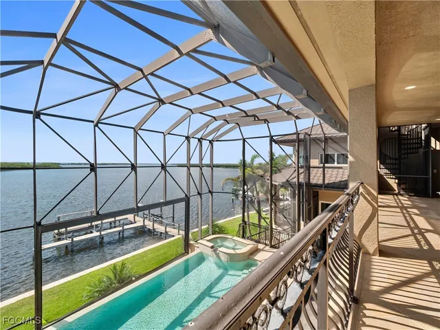a view of a roof deck with couches and ocean view