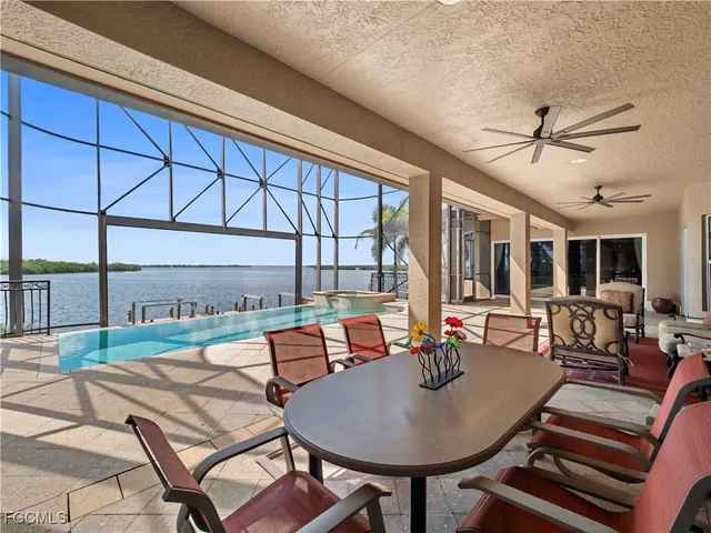 a view of a balcony with wooden benches and ocean view