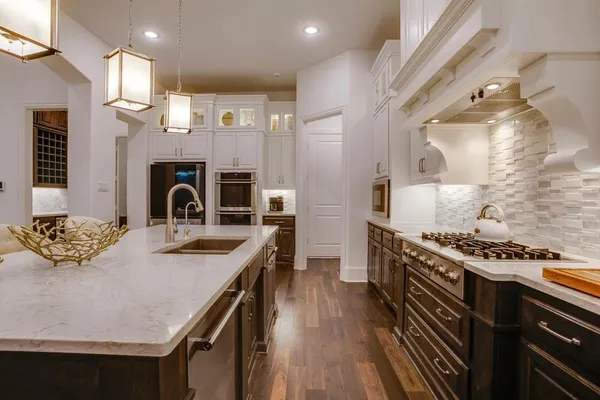 a kitchen with a stove and a wooden floors