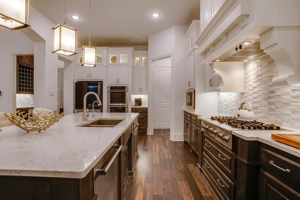 4059 Marble Hill Road Frisco, TX 75034 - Photo 12 of 40 a kitchen with a stove and a wooden floors