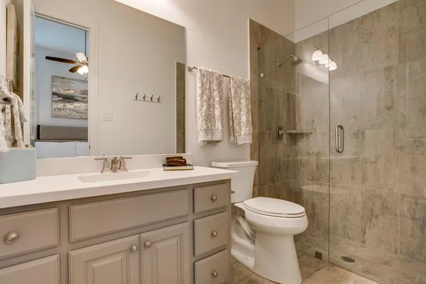 a bathroom with a sink toilet and shower
