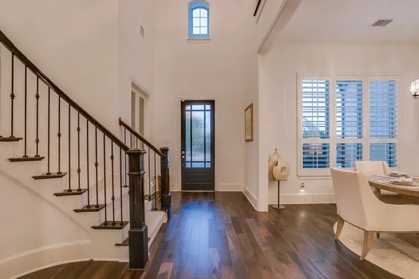 a view of a livingroom with wooden floor and stairs