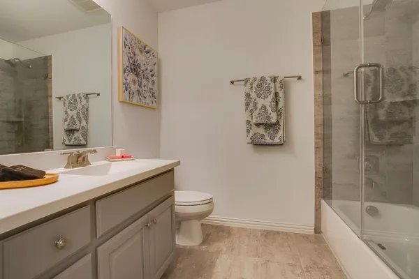 a bathroom with a sink toilet and shower
