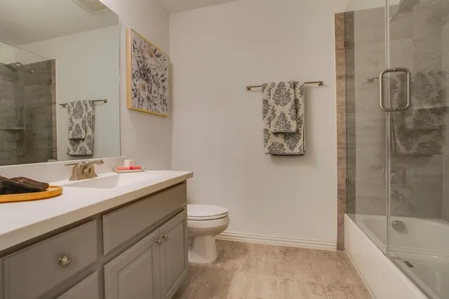 a bathroom with a sink toilet and shower