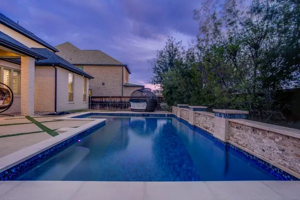 a view of a house with pool and sitting area