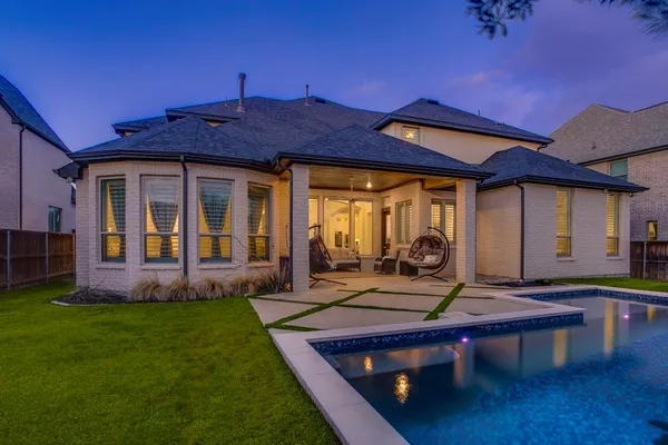 a view of a house with backyard porch and sitting area