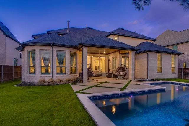 a view of a house with backyard porch and sitting area