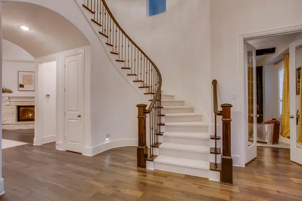 a view of entryway and hall with wooden floor