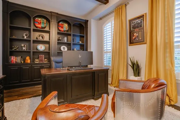 a living room with stainless steel appliances furniture and decor