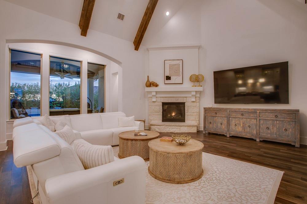 4059 Marble Hill Road Frisco, TX 75034 - Photo 9 of 40 a living room with furniture a flat screen tv and a fireplace