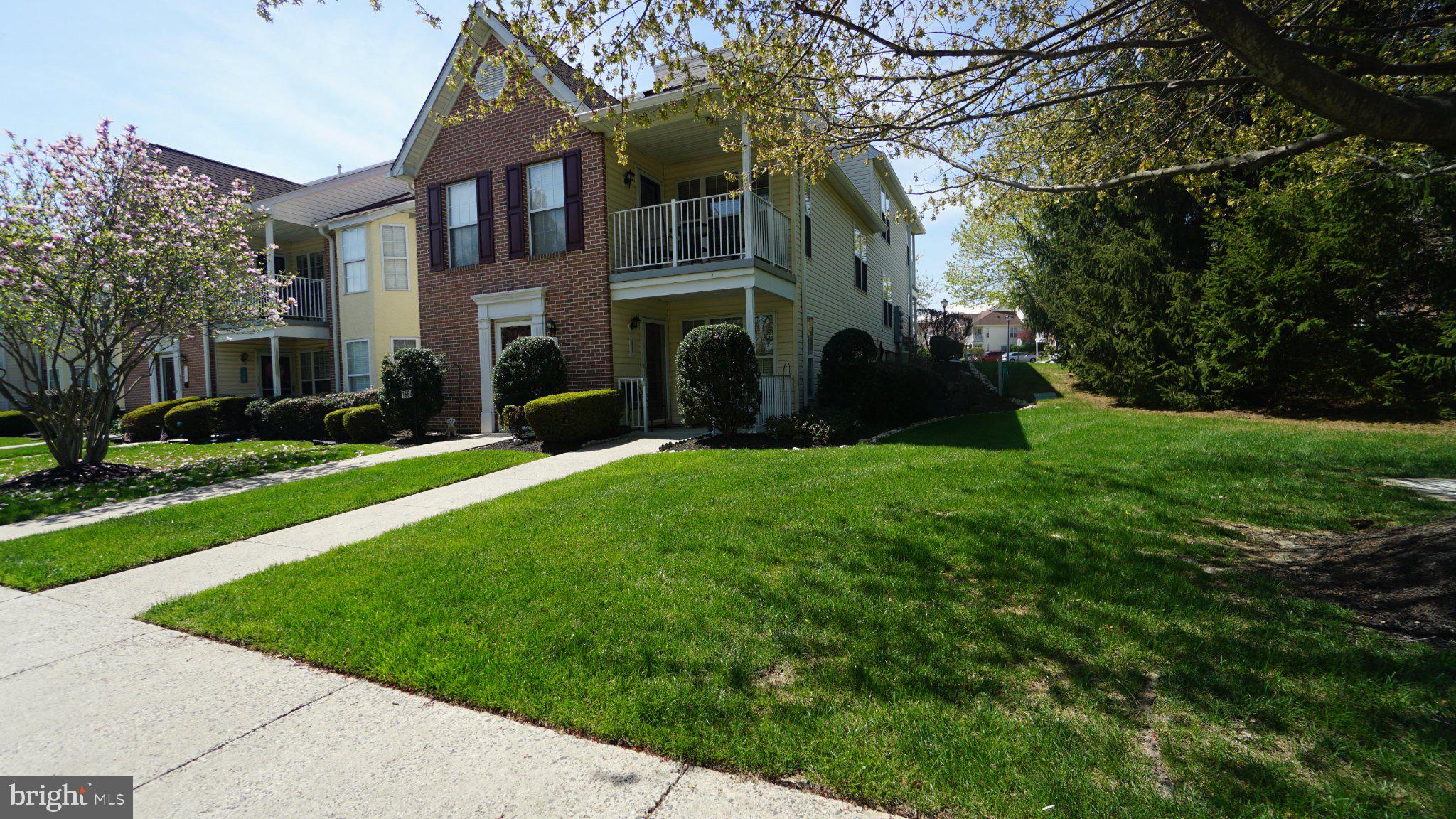 Charming duplex with lush greenery.