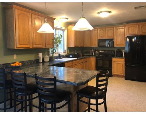 212 Brookfield Road Fiskdale, MA 01518 - Photo 7 of 19 a kitchen with granite countertop a stove a sink a dining table and chairs