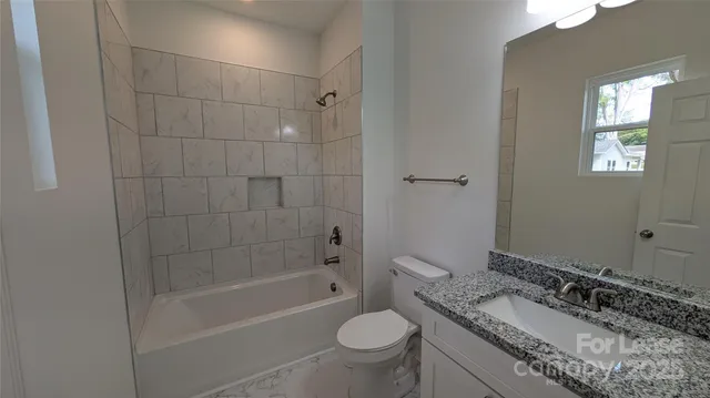 a view of a hallway with wooden floor and closet
