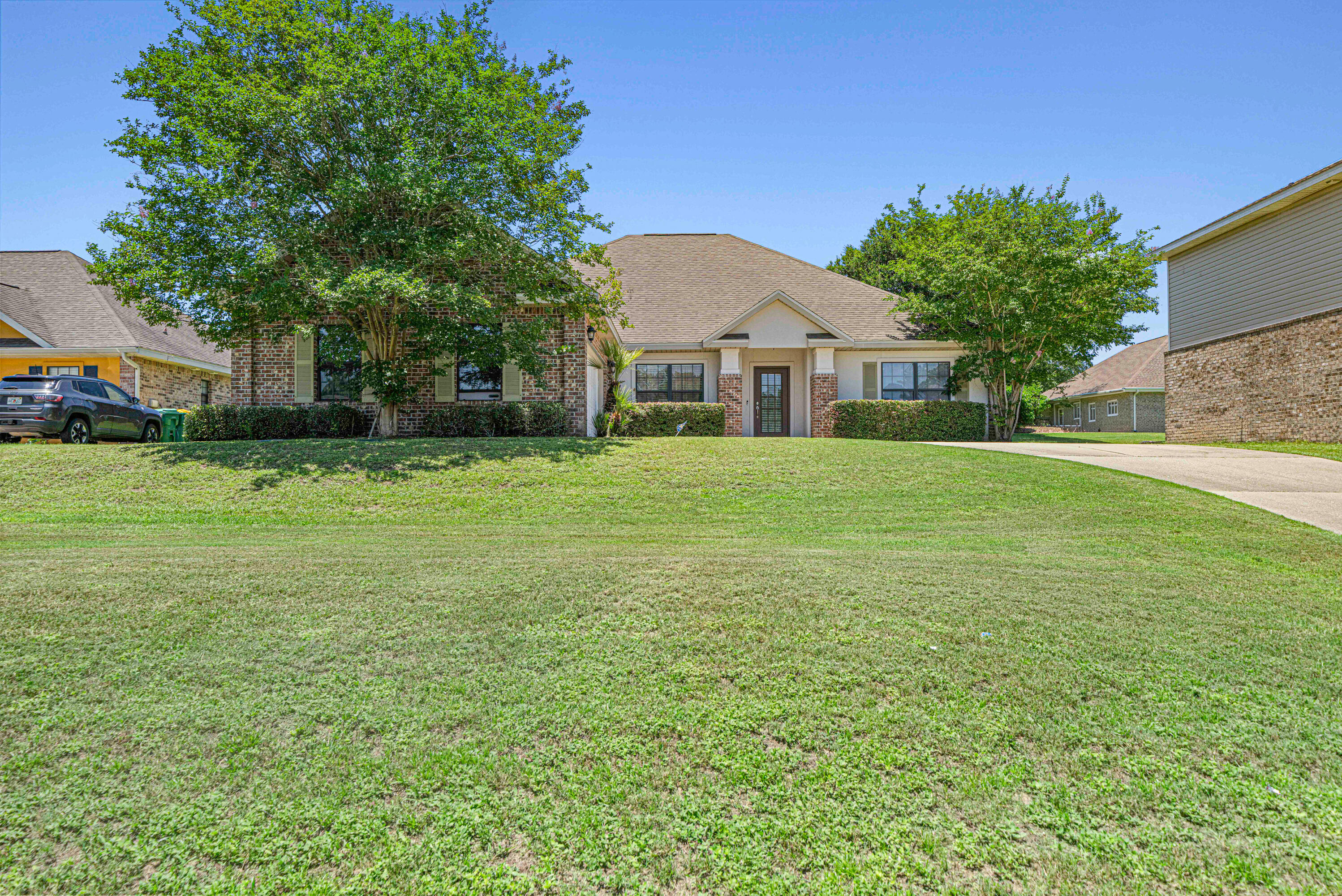 3263 Chapelwood Drive Crestview, FL 32539 - Photo 2 of 39 a front view of a house with a yard