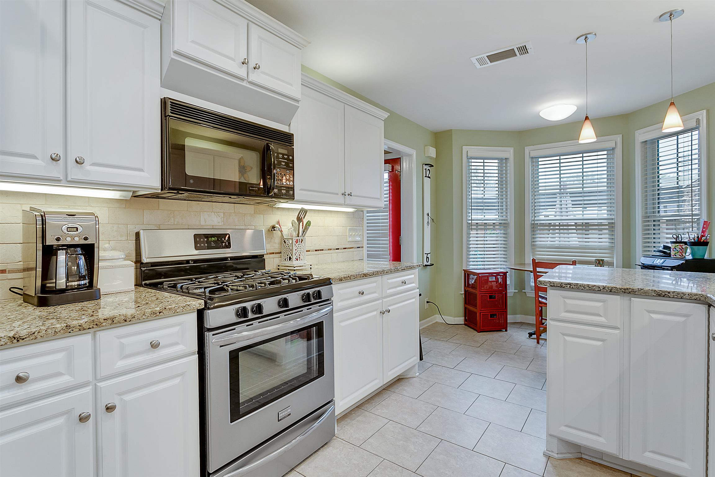 1309 General George Patton Road, Unit 1309 Nashville, TN 37221 - Photo 1 of 30 Tasteful, timeless high-end finishes in this renovated kitchen! Gas range; large microwave; gorgeous granite; new cabinets with over- & under-cabinet lighting. The tile floor is practical & pretty, coordinating beautifully with the tile backsplash.